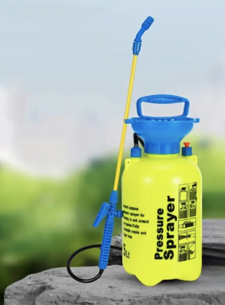 5L Pressure Sprayer standing on rock - adjustable nozzle and trigger lock visible